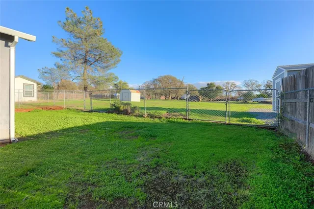 a view of an house with a big yard and potted plants
