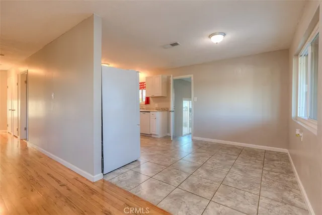 a view of a kitchen with a refrigerator and a window