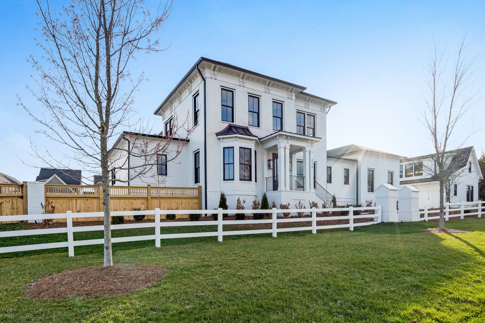 a view of a house with a yard in front of it