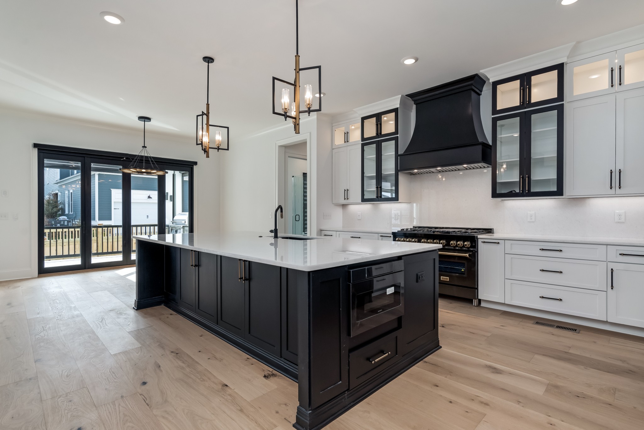 214 Old Peytonsville Road Franklin, TN 37064 - Photo 15 of 42 a kitchen with stainless steel appliances granite countertop a sink a stove and a wooden floors