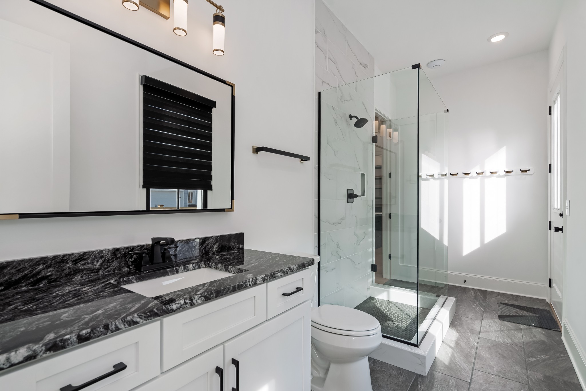 214 Old Peytonsville Road Franklin, TN 37064 - Photo 25 of 42 a bathroom with a granite countertop sink a toilet a mirror and shower