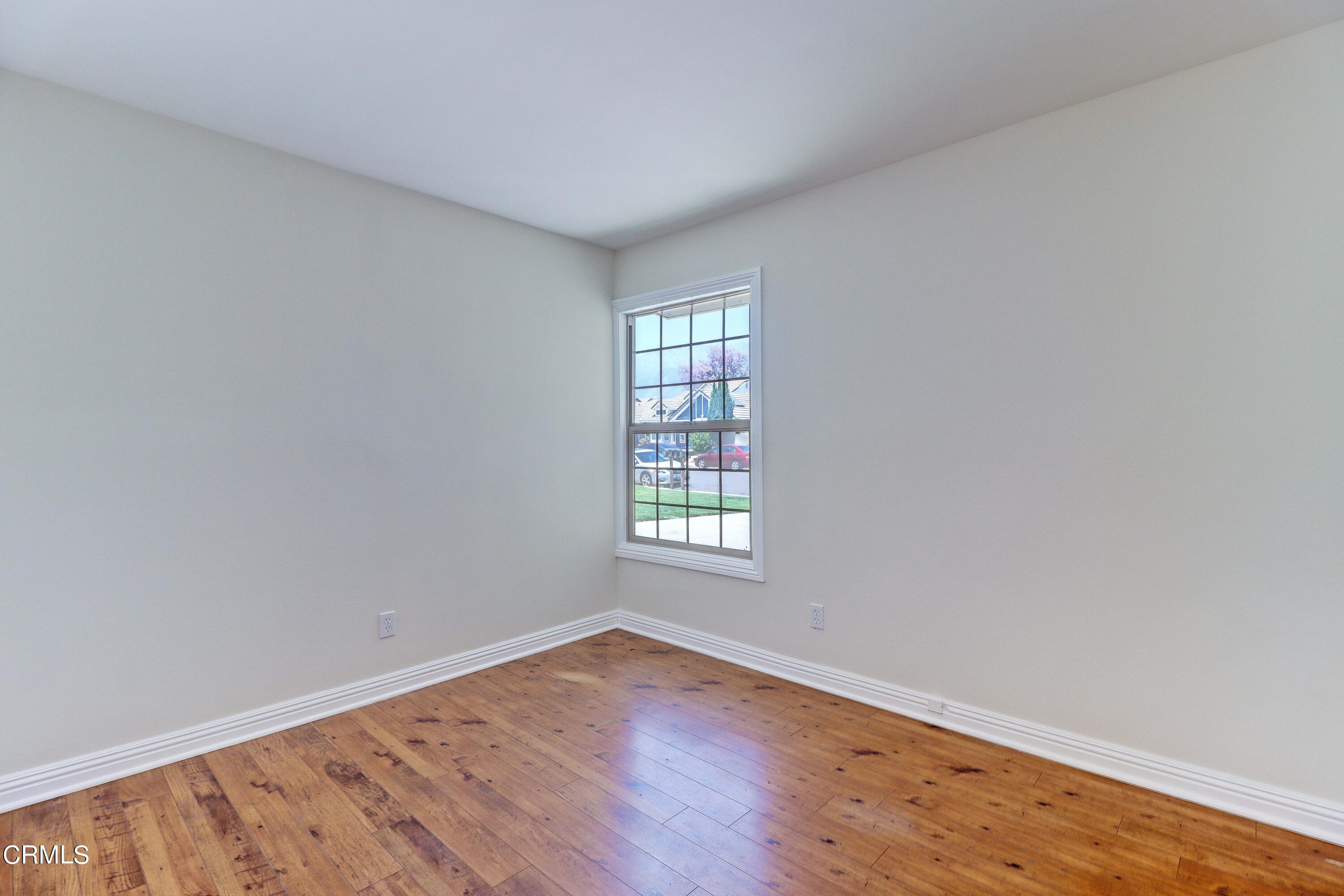12399 Blazing Star Court Rancho Cucamonga, CA 91739 - Photo 19 of 24 an empty room with wooden floor and windows