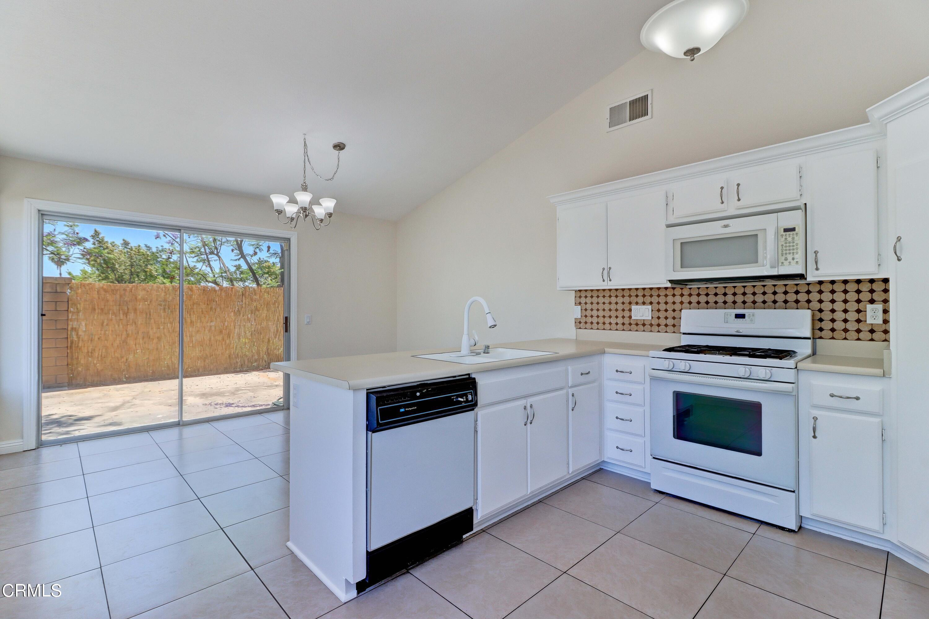 12399 Blazing Star Court Rancho Cucamonga, CA 91739 - Photo 8 of 24 a kitchen with granite countertop white cabinets and white appliances