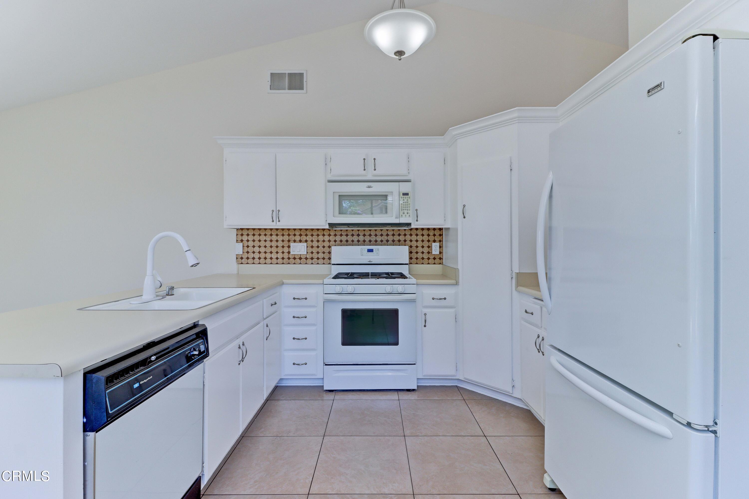 12399 Blazing Star Court Rancho Cucamonga, CA 91739 - Photo 10 of 24 a kitchen with granite countertop white cabinets and stainless steel appliances