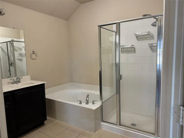 a bathroom with a bathtub sink and mirror