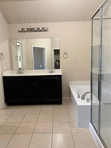 an empty room with wooden floor fireplace and windows