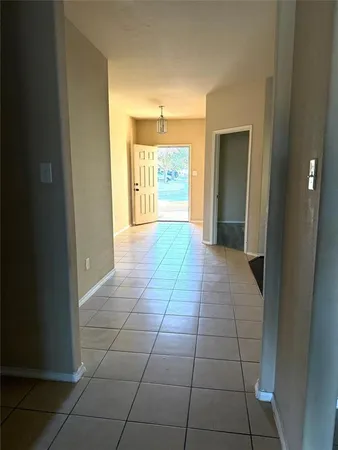 a view of hallway with a window and kitchen view