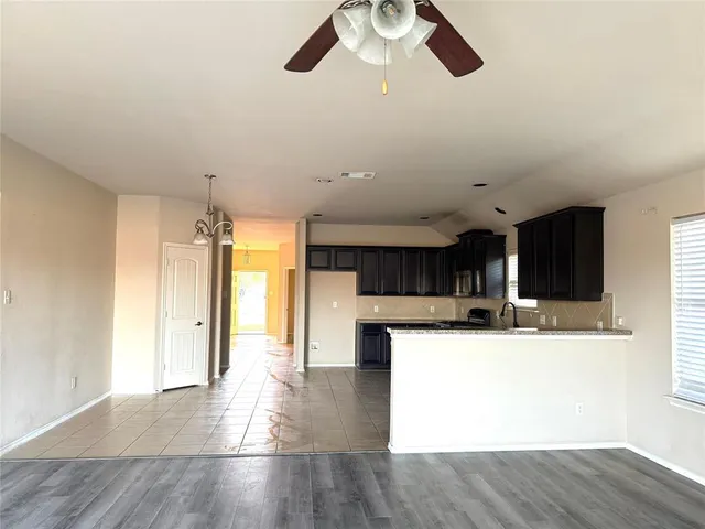 a view of a kitchen with a sink stainless steel appliances and cabinets