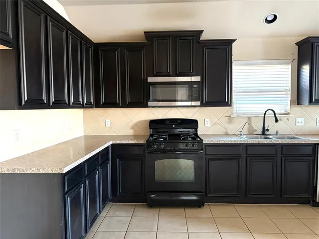 a kitchen with a sink and a stove