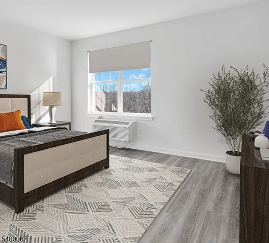 a living room with a bed furniture and a large window