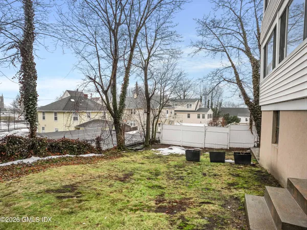 a view of a house with a yard covered in snow