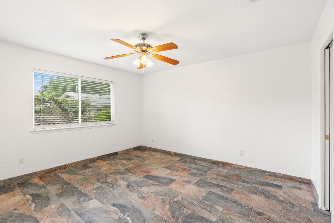 2406 Berkeley Avenue, Unit B Austin, TX 78745 - Photo 13 of 24 an empty room with a window and a fan
