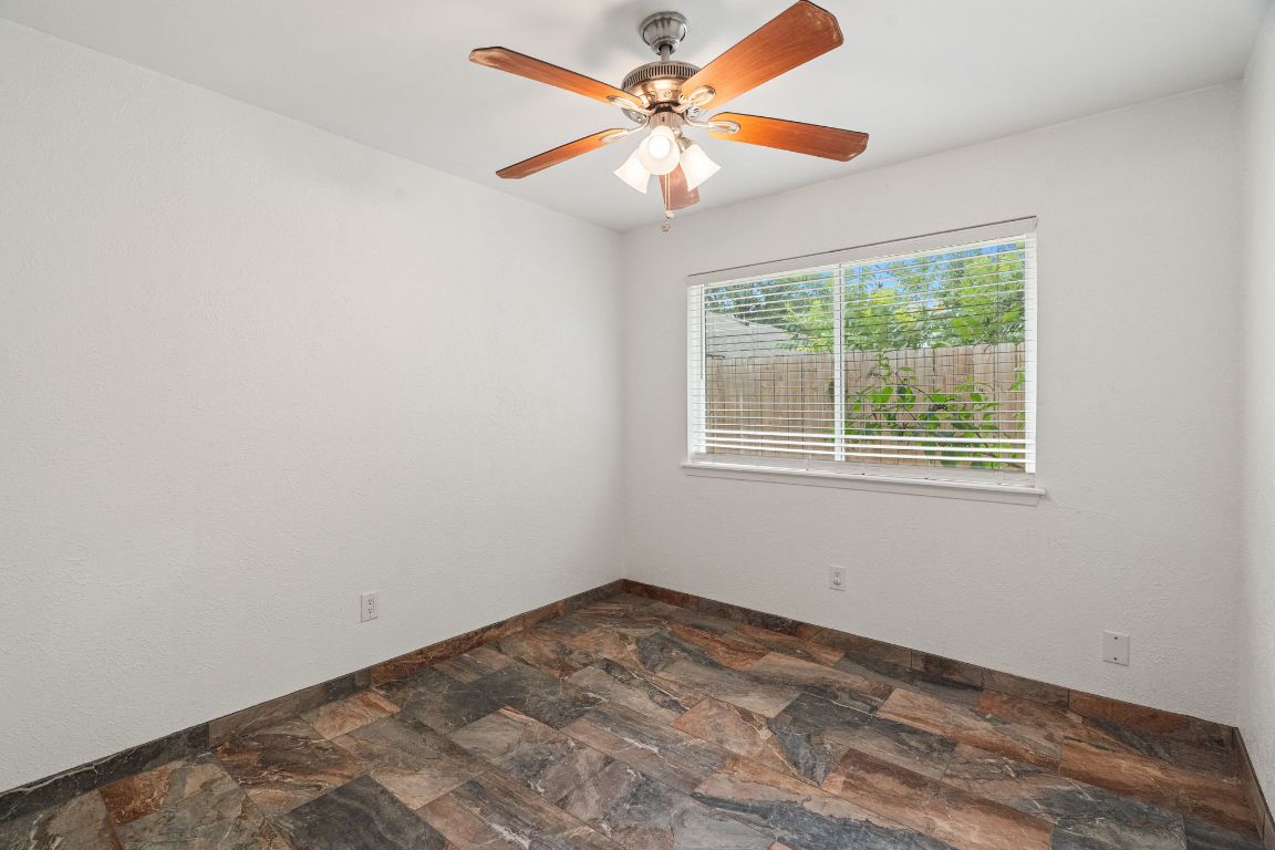 2406 Berkeley Avenue, Unit B Austin, TX 78745 - Photo 18 of 24 an empty room with a window and a fan