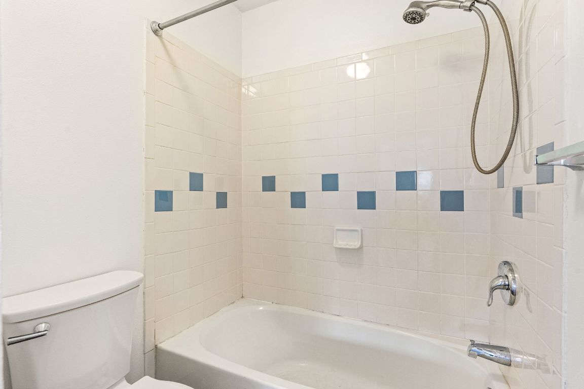 2406 Berkeley Avenue, Unit B Austin, TX 78745 - Photo 19 of 24 a bathroom with a shower a toilet and a sink