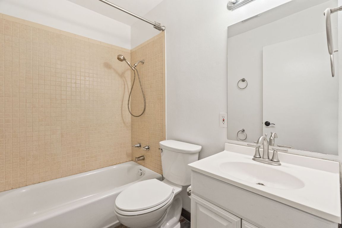 2406 Berkeley Avenue, Unit B Austin, TX 78745 - Photo 20 of 24 a bathroom with a sink toilet vanity and shower