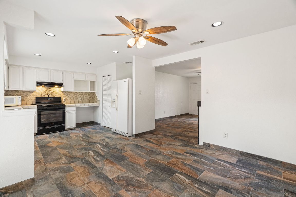 2406 Berkeley Avenue, Unit B Austin, TX 78745 - Photo 6 of 24 a view of a kitchen with a sink and a refrigerator