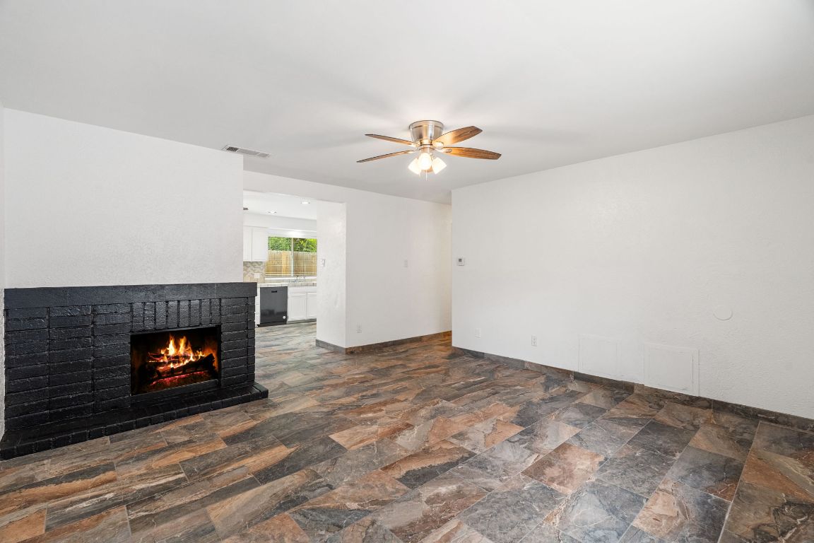 2406 Berkeley Avenue, Unit B Austin, TX 78745 - Photo 10 of 24 a living room with furniture and a fireplace
