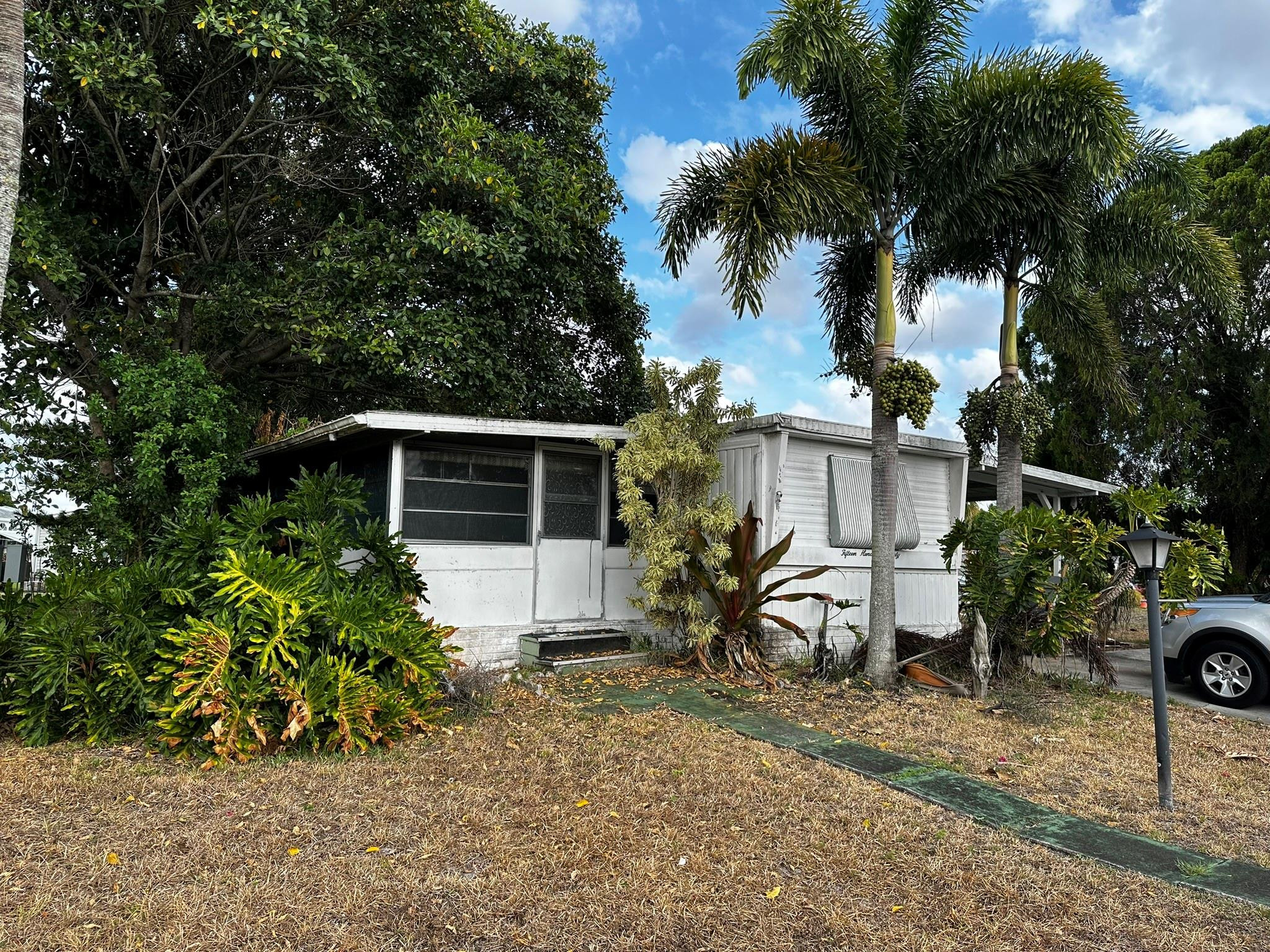 1590 Southwest 65th Terrace Boca Raton, FL 33428 - Photo 3 of 13 a view of house with backyard space and slide