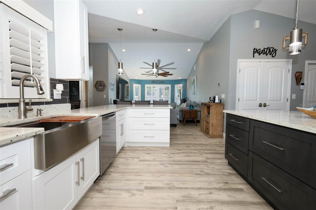 424 Meadow Green Drive Davenport, FL 33837 - Photo 13 of 47 a large kitchen with stainless steel appliances kitchen island granite countertop a large counter top and sink