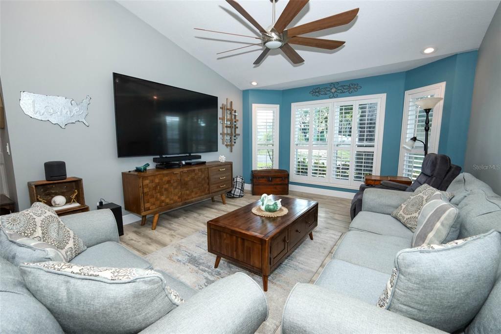 424 Meadow Green Drive Davenport, FL 33837 - Photo 16 of 47 a living room with furniture and a flat screen tv