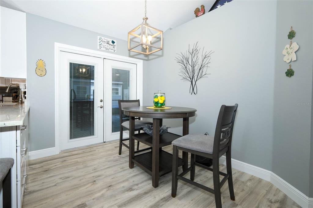424 Meadow Green Drive Davenport, FL 33837 - Photo 19 of 47 a view of a dining room with furniture and chandelier
