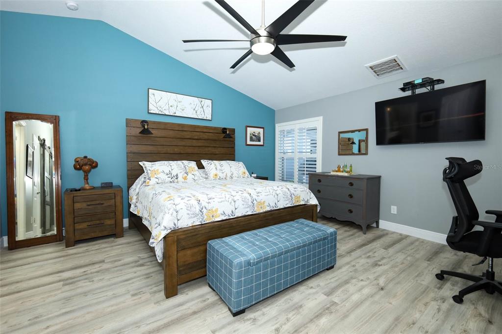 424 Meadow Green Drive Davenport, FL 33837 - Photo 22 of 47 a bedroom with a bed a flat screen tv and dresser