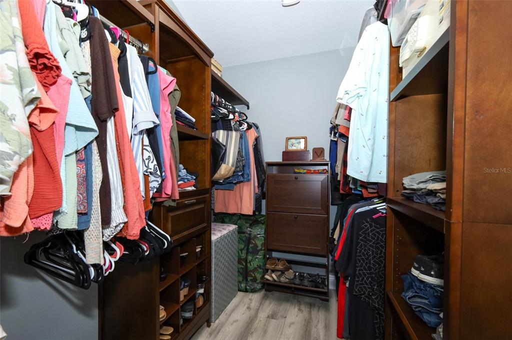 424 Meadow Green Drive Davenport, FL 33837 - Photo 28 of 47 a view of walk in closet with clothes and shoes