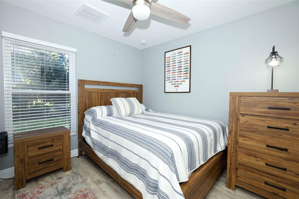 424 Meadow Green Drive Davenport, FL 33837 - Photo 29 of 47 a bedroom with a bed and a dresser