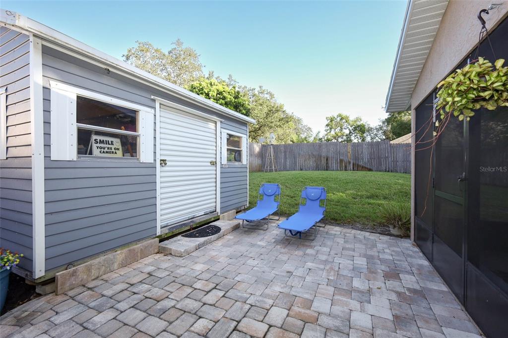 424 Meadow Green Drive Davenport, FL 33837 - Photo 39 of 47 a view of a backyard with chairs potted plants and wooden fence
