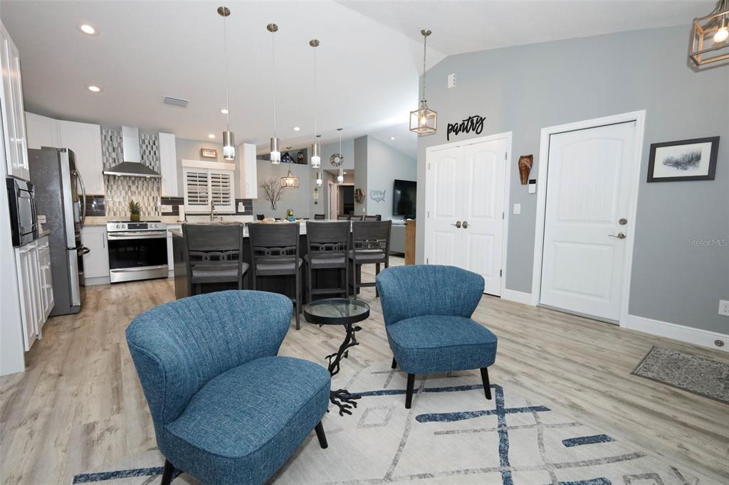 424 Meadow Green Drive Davenport, FL 33837 - Photo 5 of 47 a living room with furniture kitchen and a refrigerator