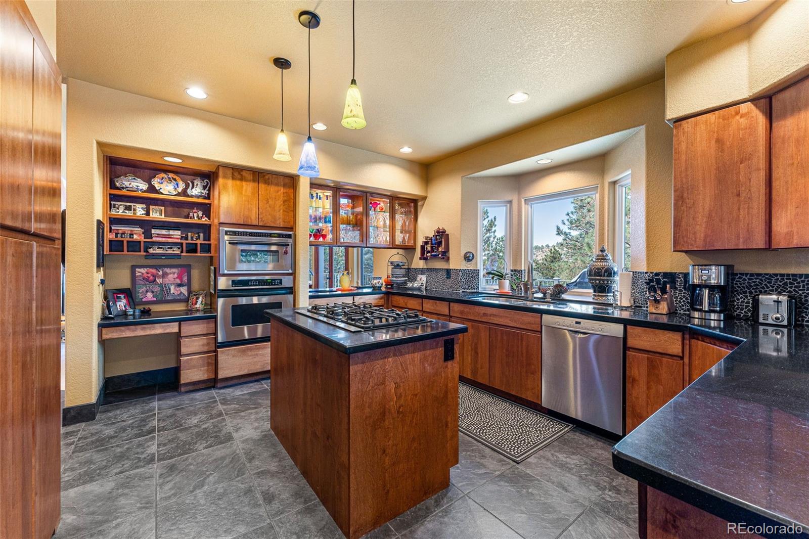 395 Timber Lane Boulder, CO 80304 - Photo 11 of 37 a kitchen with stainless steel appliances granite countertop a stove and a refrigerator