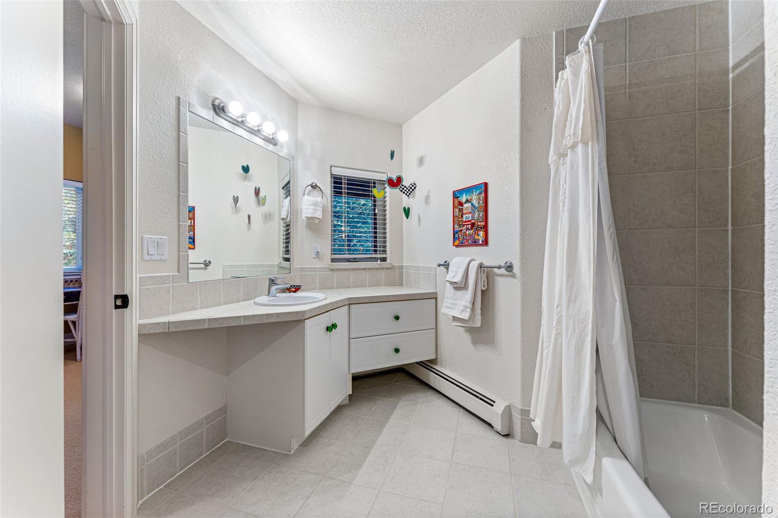 395 Timber Lane Boulder, CO 80304 - Photo 25 of 37 a bathroom with a double vanity sink mirror and bathtub