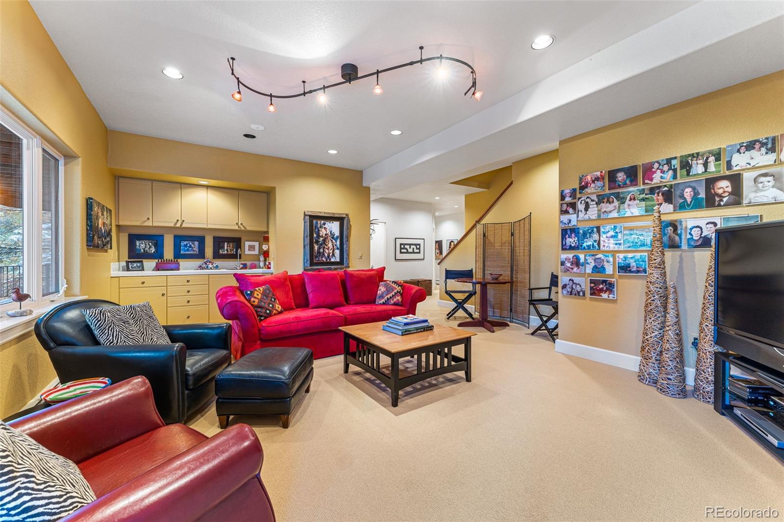 395 Timber Lane Boulder, CO 80304 - Photo 28 of 37 a living room with furniture gym equipment and a flat screen tv