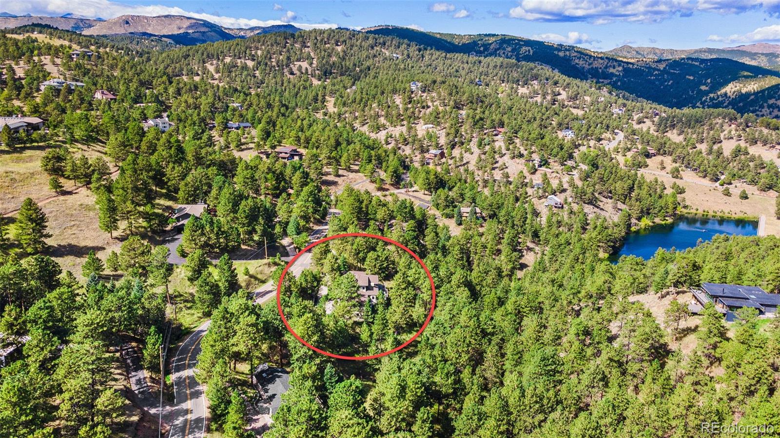 395 Timber Lane Boulder, CO 80304 - Photo 36 of 37 a view of a lush green field with a tree in the background