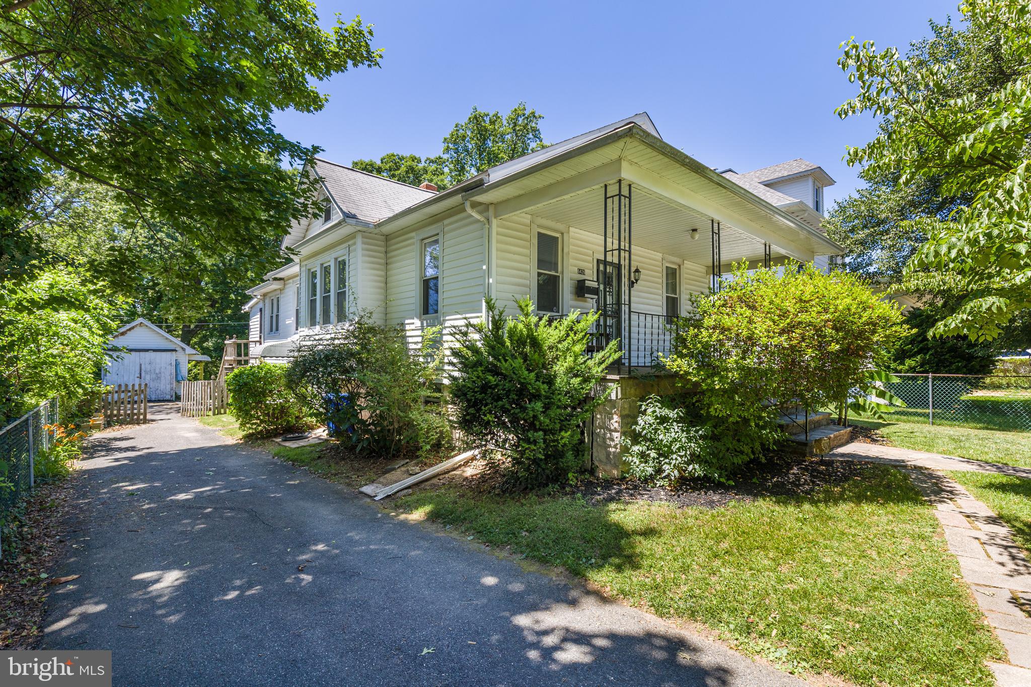 6426 Sherwood Road Baltimore, MD 21239 - Photo 36 of 43 a front view of a house with a yard and trees