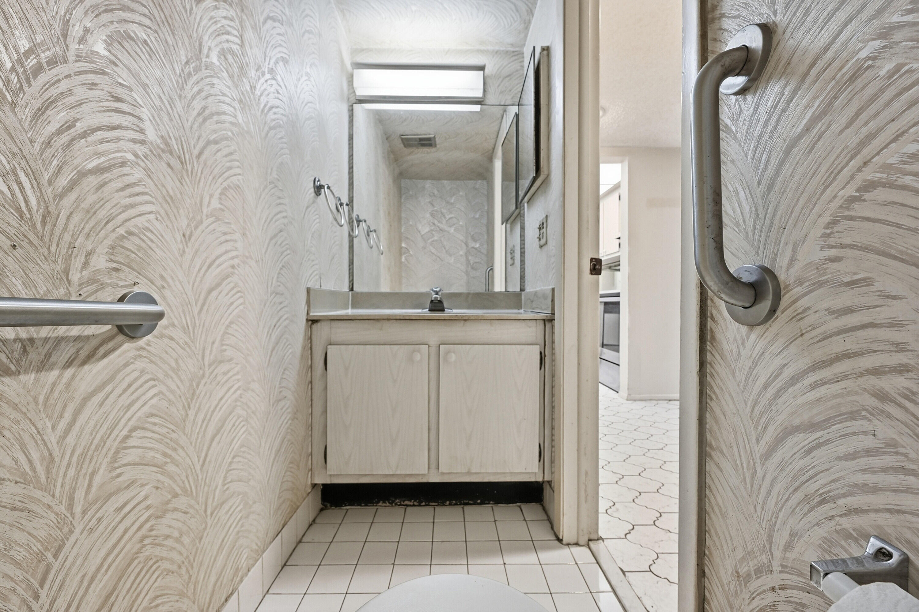 6195 Rock Island Road, Unit 210 Tamarac, FL 33319 - Photo 12 of 26 a view of a bathroom with mirror