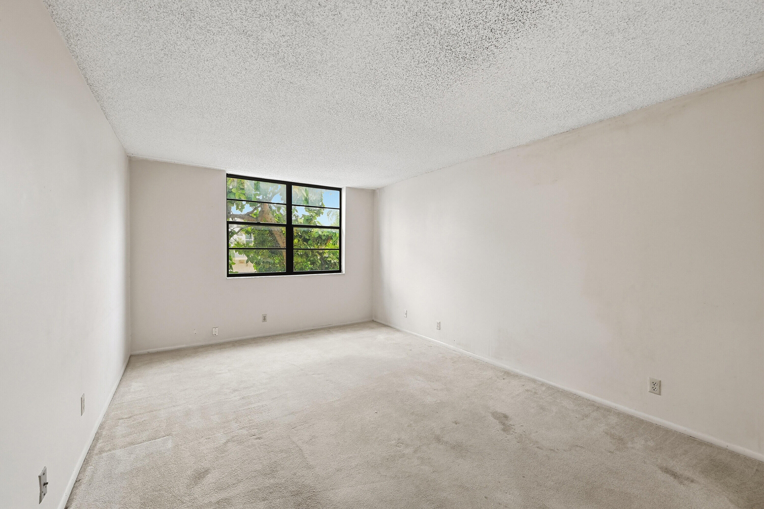 6195 Rock Island Road, Unit 210 Tamarac, FL 33319 - Photo 13 of 26 an empty room with windows