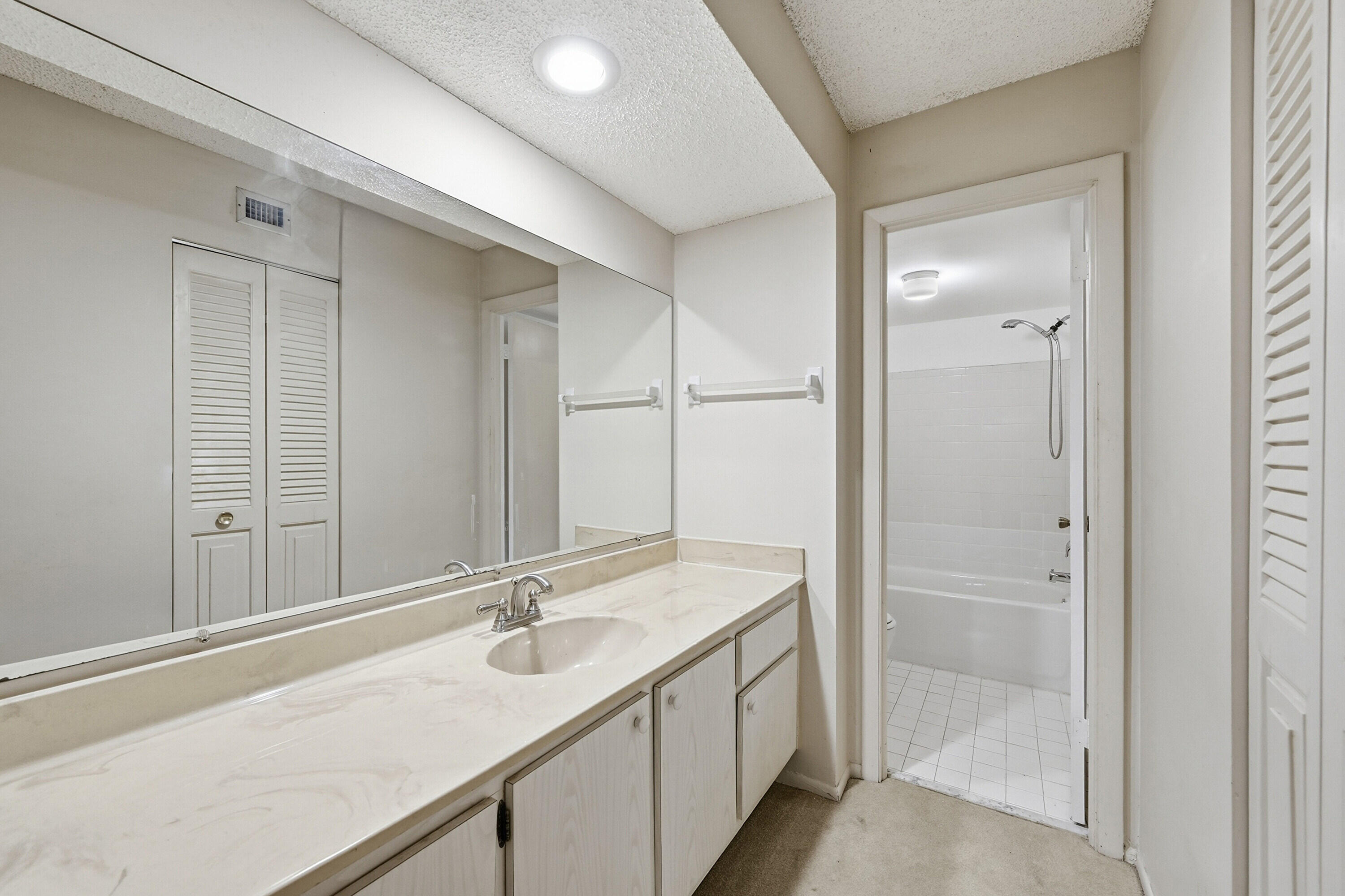 6195 Rock Island Road, Unit 210 Tamarac, FL 33319 - Photo 17 of 26 a bathroom with a sink and a mirror