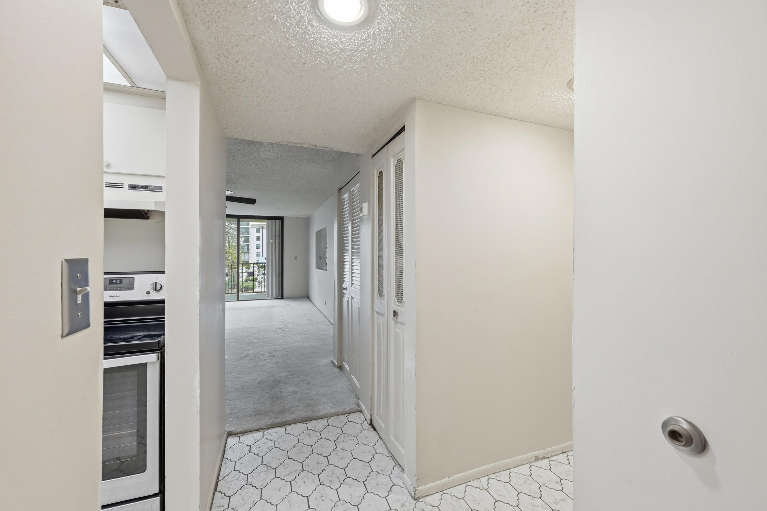 6195 Rock Island Road, Unit 210 Tamarac, FL 33319 - Photo 2 of 26 a view of a hallway with wooden floor and closet