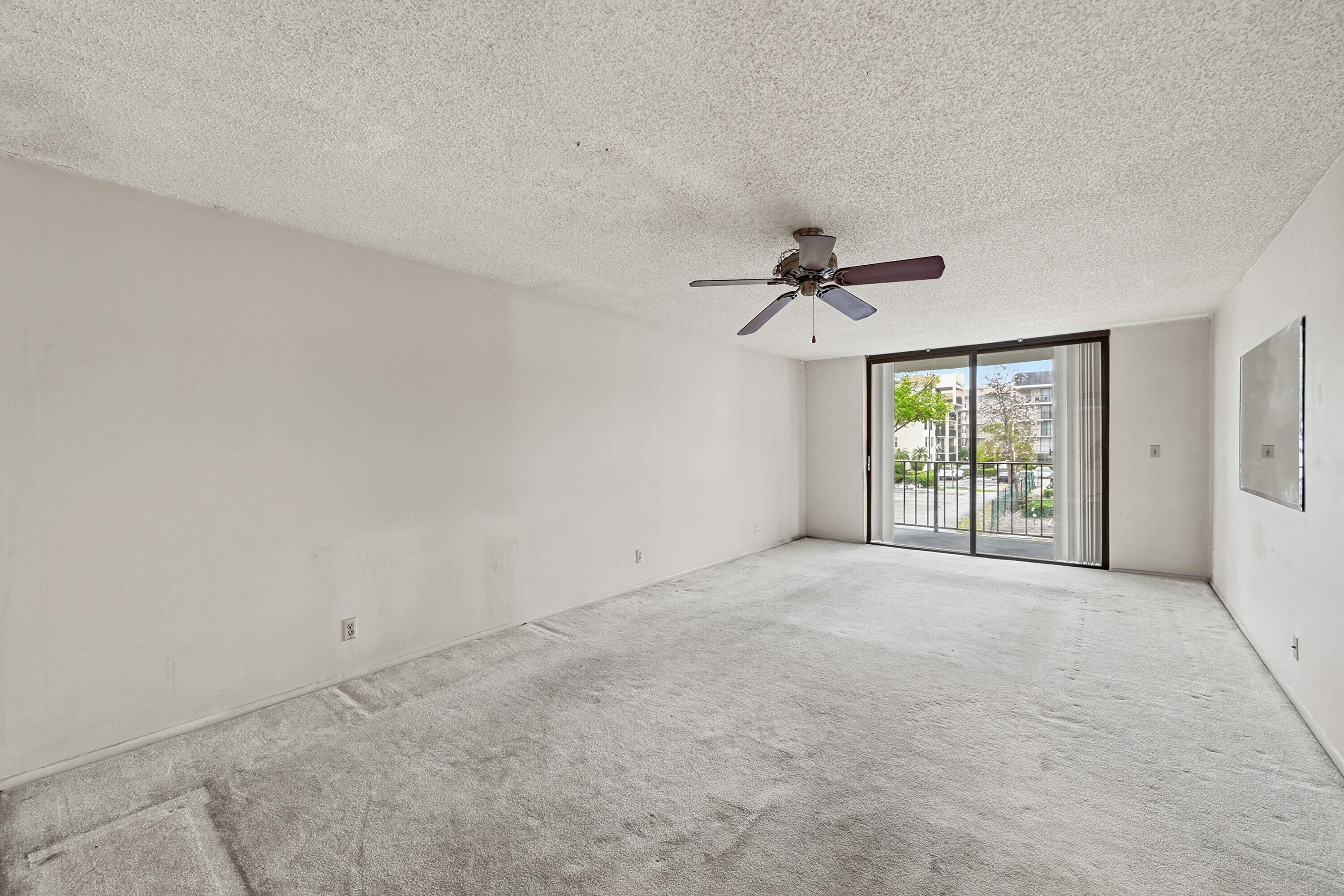 6195 Rock Island Road, Unit 210 Tamarac, FL 33319 - Photo 4 of 26 a view of an empty room with a window