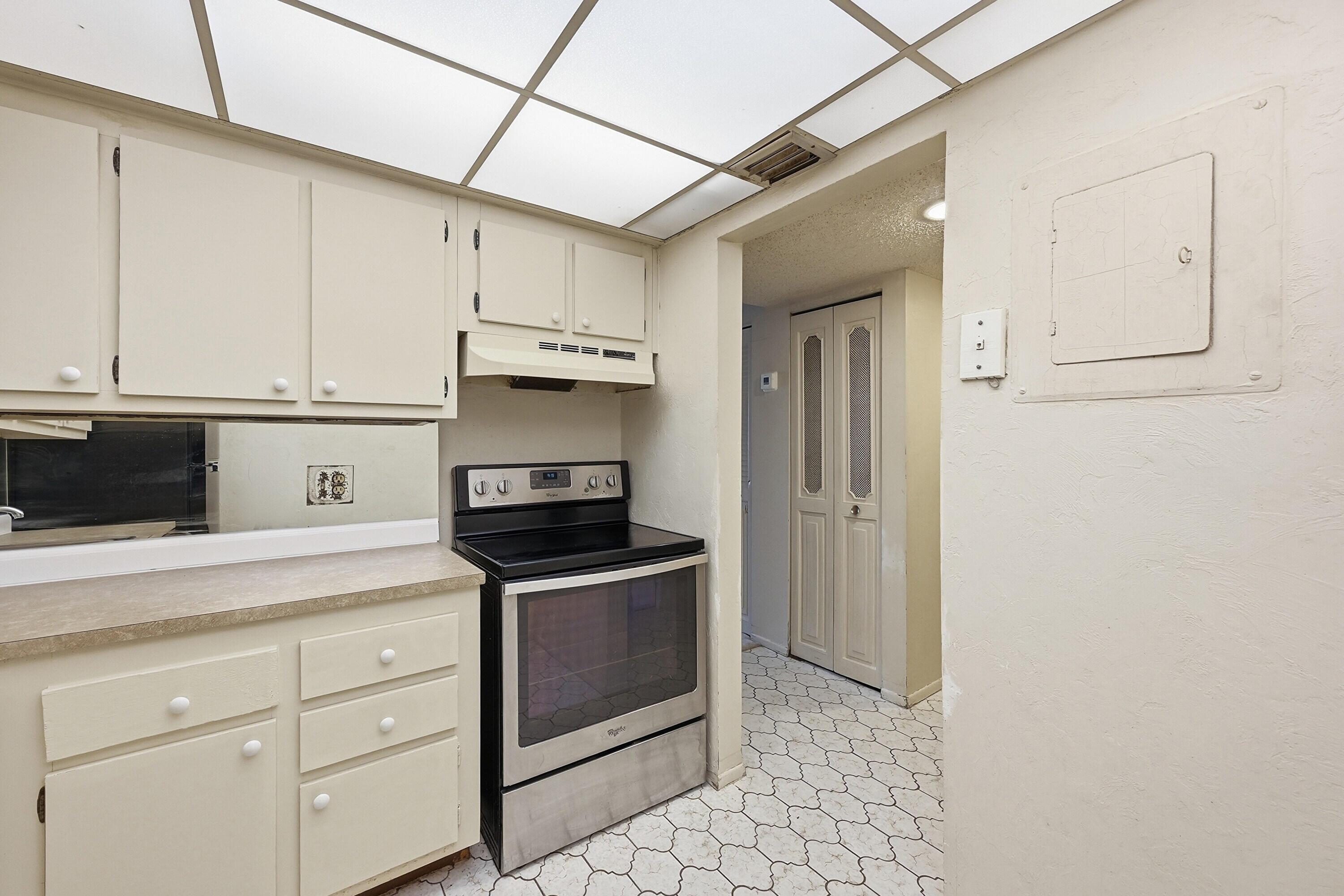 6195 Rock Island Road, Unit 210 Tamarac, FL 33319 - Photo 10 of 26 a kitchen with stainless steel appliances granite countertop a refrigerator and a stove