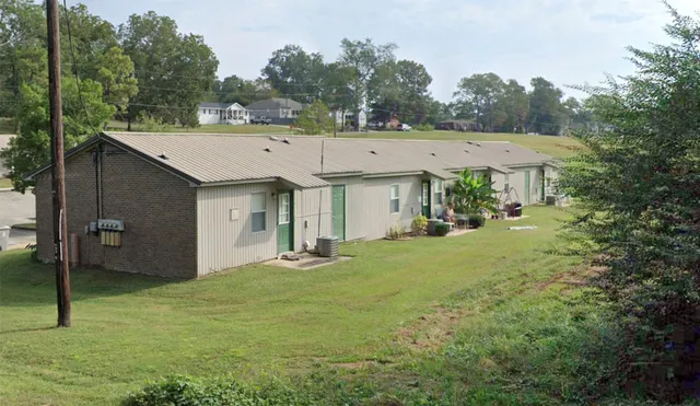 a view of a house with a backyard and a tree