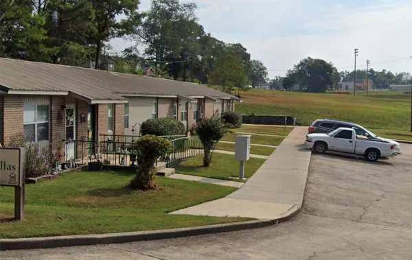 a view of a house with swimming pool and a yard