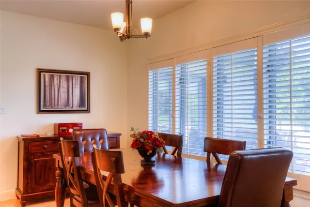 a view of a dining room with furniture wooden floor and chandelier
