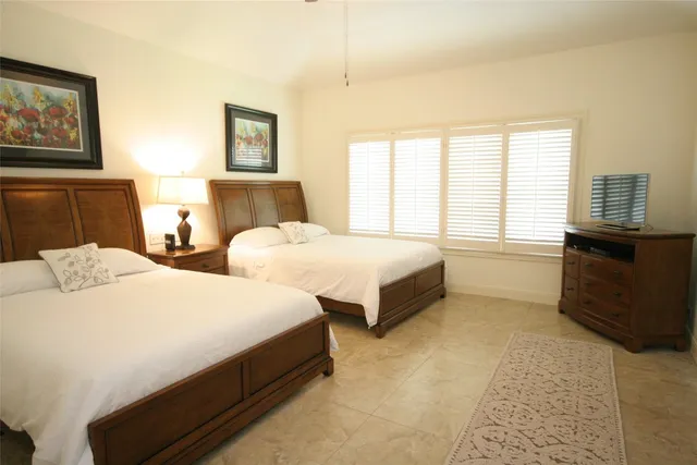 a bedroom with two beds and painting on the wall