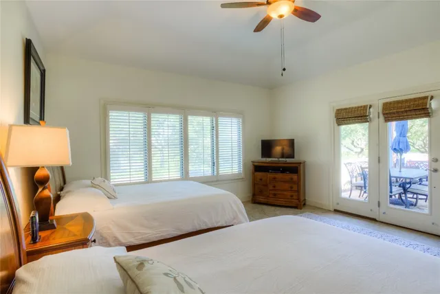 a bedroom with two beds and a chandelier