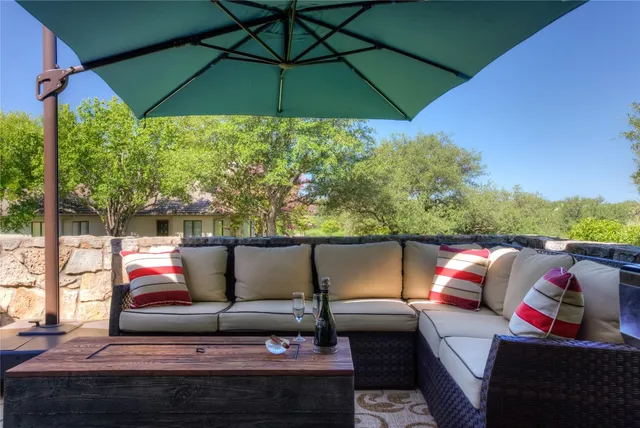 a view of a outdoor sitting area with furniture and umbrella
