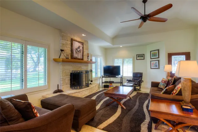 a living room with furniture flat screen tv and a fireplace