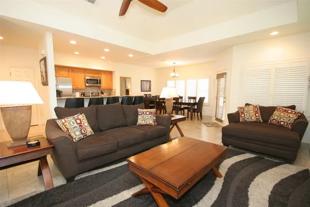 a living room with furniture a rug and a chandelier