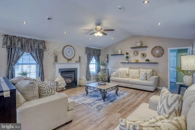 a living room with furniture a fireplace and a chandelier